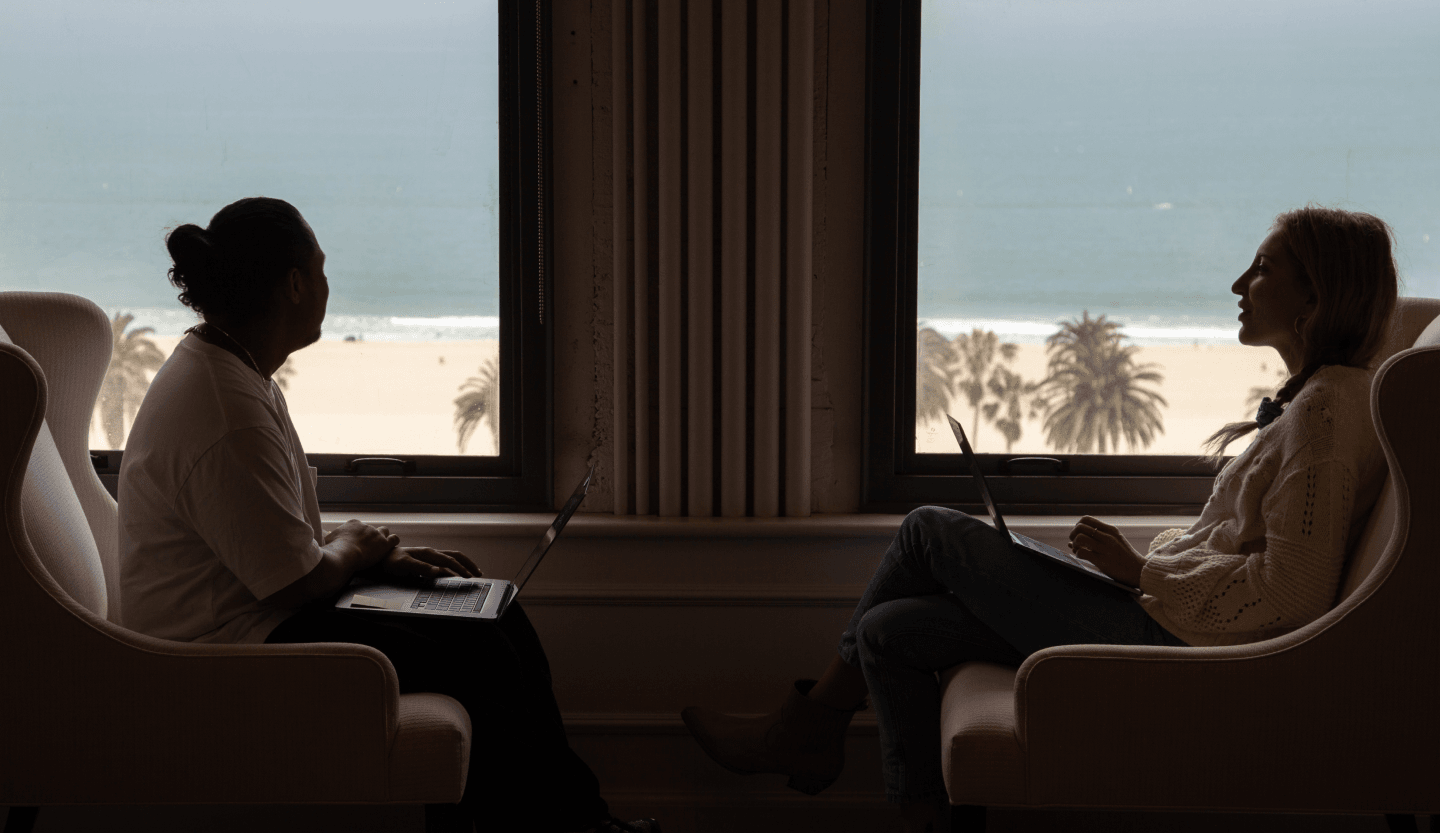 employees next to window looking at ocean